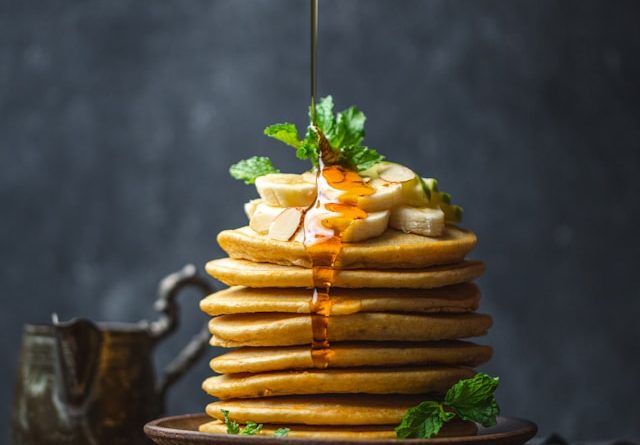Sweet Delight: Drizzling honey over perfect pancakes